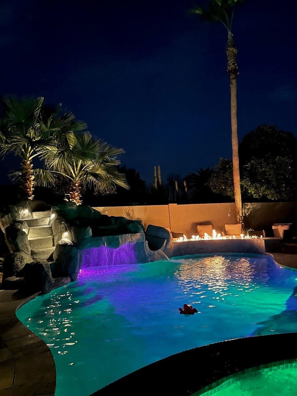 Pool at night with gas fireplace on