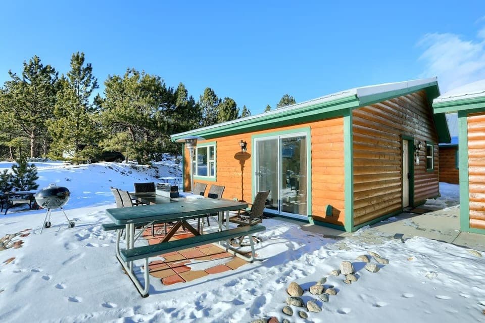 The exterior of our Moose cabin with patio seating just outside your door.