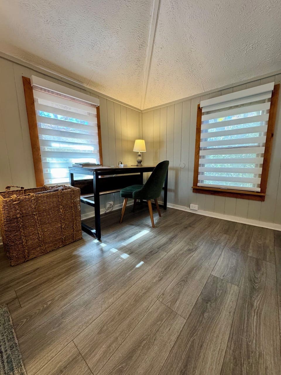 Bright home office with desk, comfy chair & wooded views