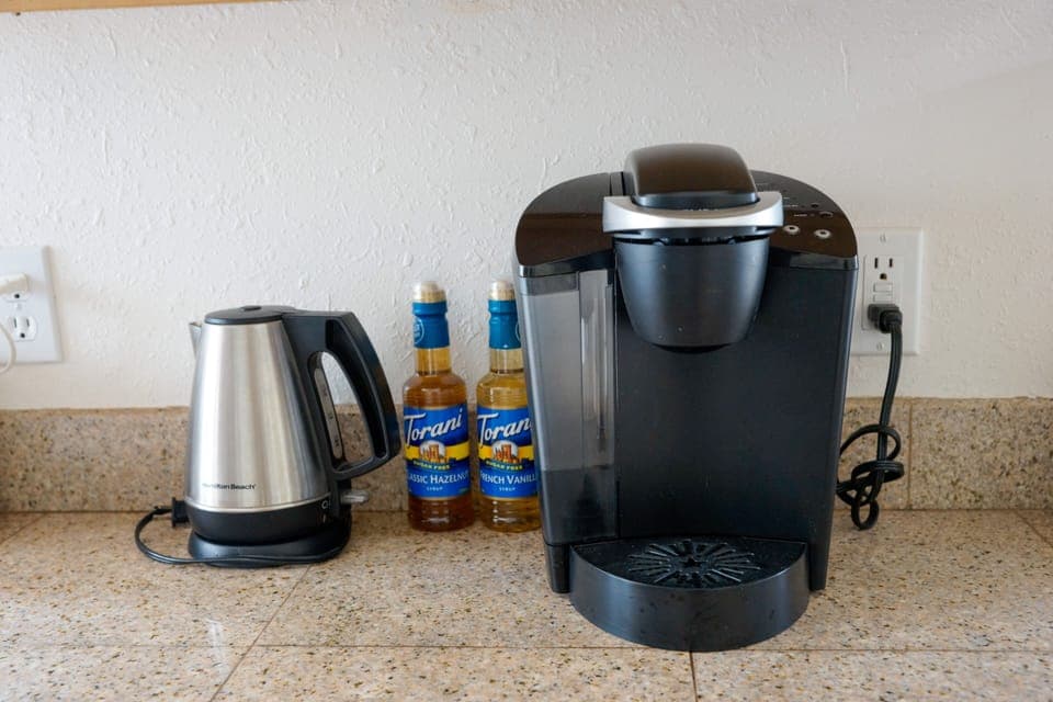 Keurig and hot pot, full coffee pot, filters and coffee grounds stocked too.