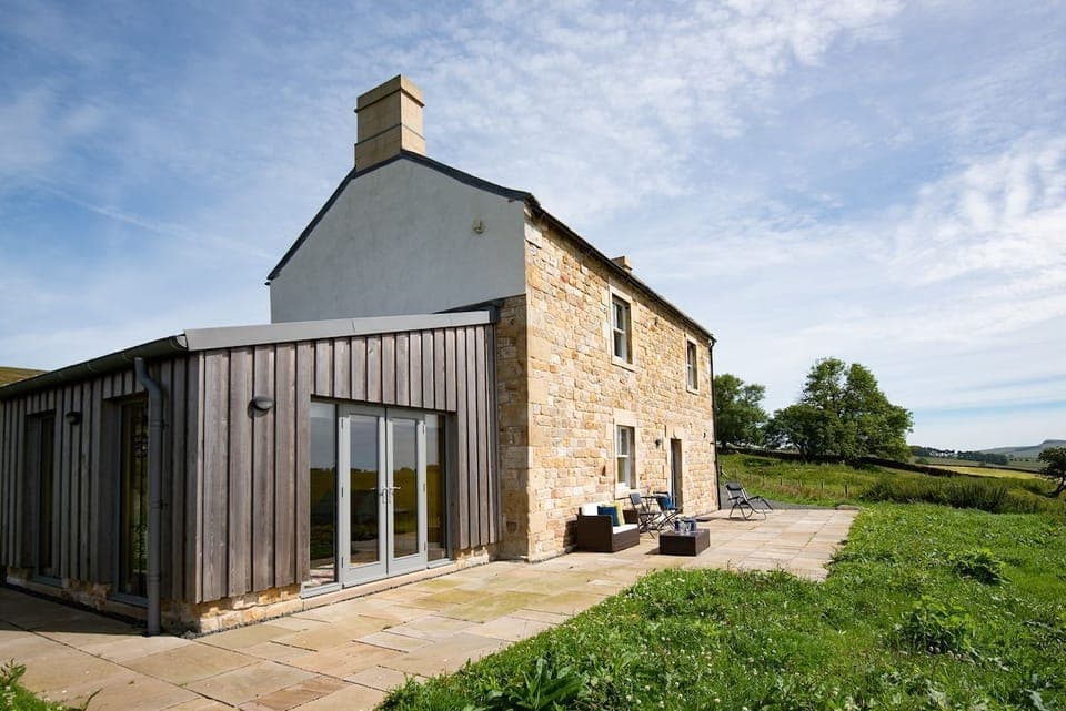 Lowtown Cottage - exterior with traditional Northumbrian brickwork and sun room extension