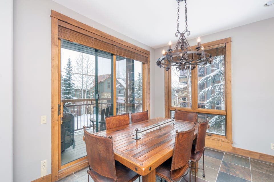 Dining room with wood furniture and snowy views