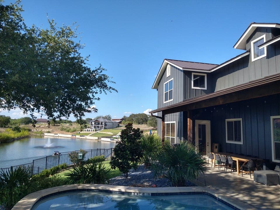 Back yard view of pool, covered patio and cove