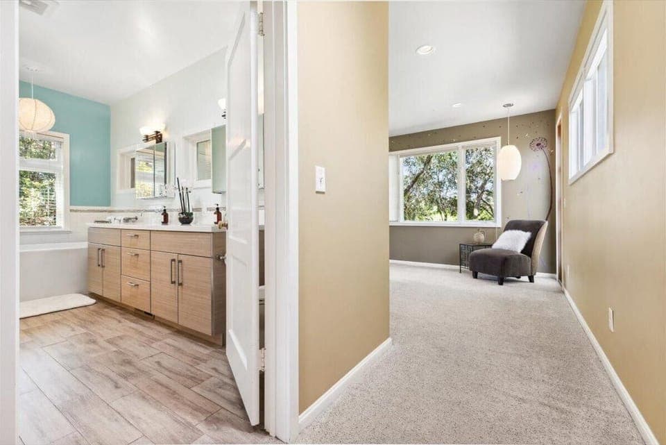 Main House En-Suite - Bright, airy hallway leading to a cozy sitting nook and spacious bathroom