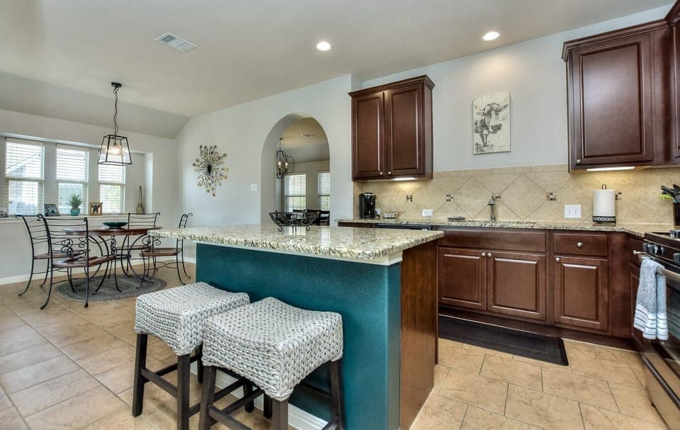 Huge kitchen island with two comfy bar stools…