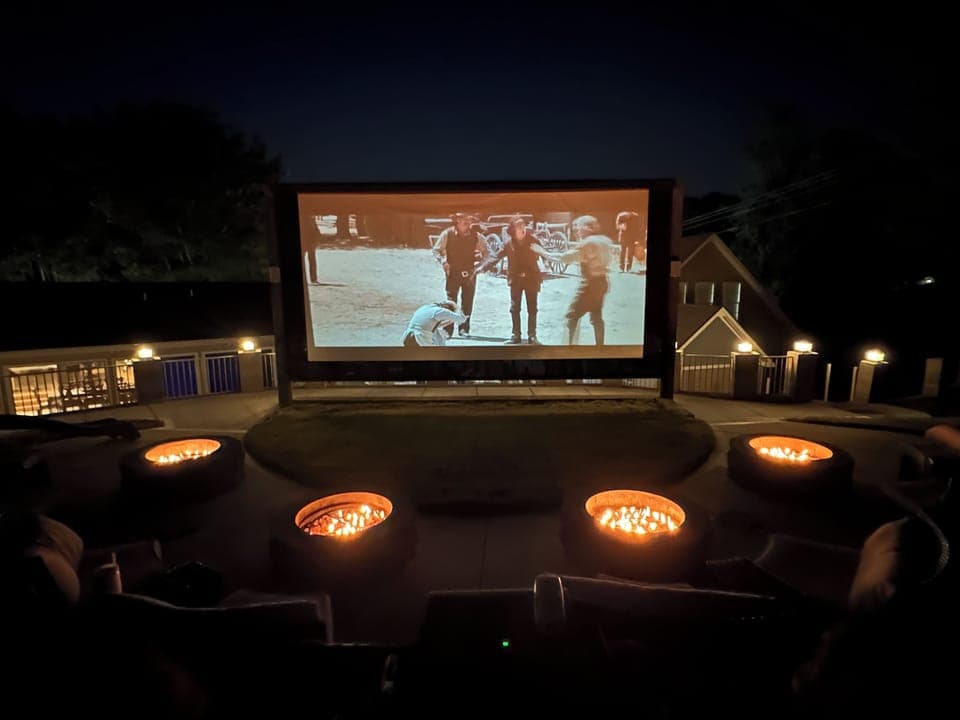 Large outdoor movie experience with surround sound and gas fire pits.