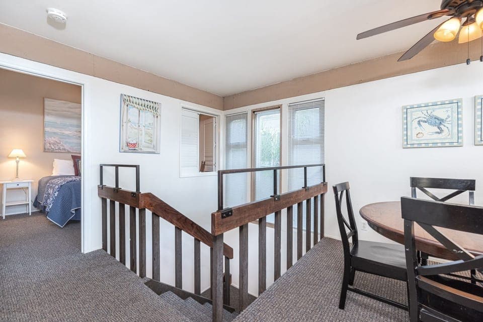 Stairs lead from the first floor bedrooms to the second floor primary bedroom and living areas.
                