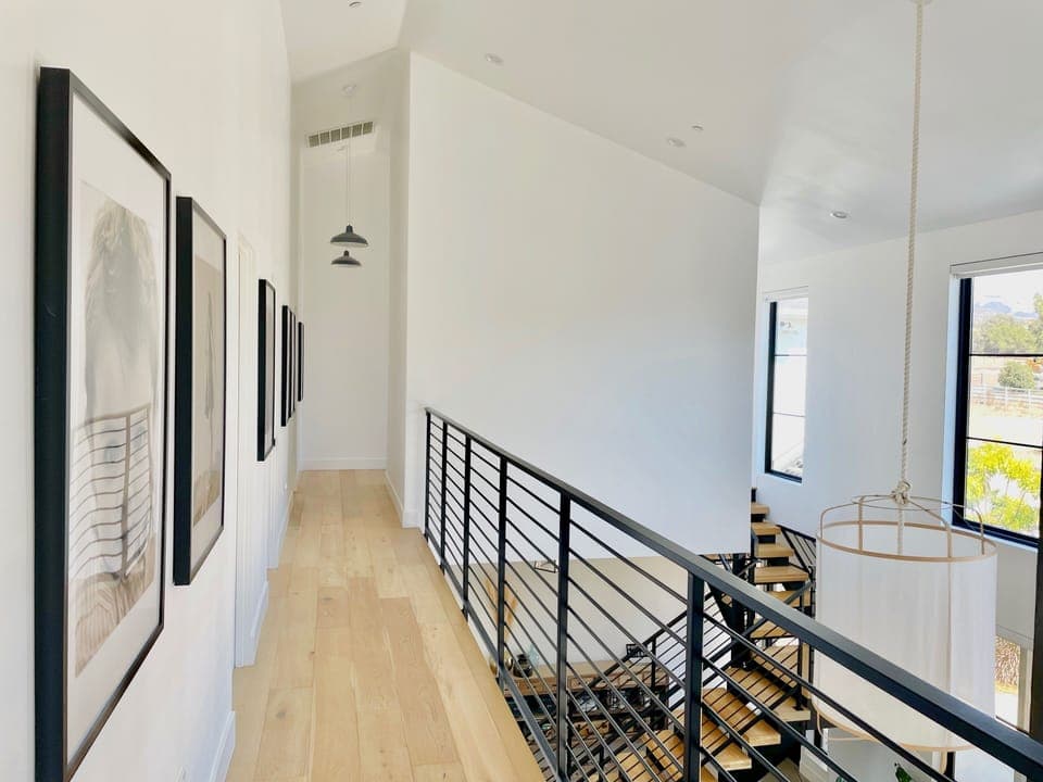 Upstairs hallway leads to all of the bedrooms and overlooks the living area below.