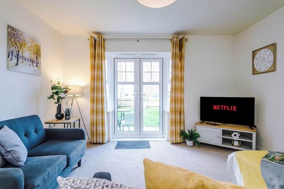 Open plan living room benefiting from a large double sofa bed and Smart TV.