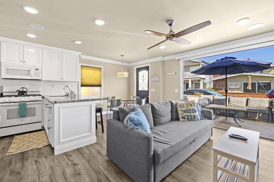 Living room with bifold doors to patio, great space to hang all day!