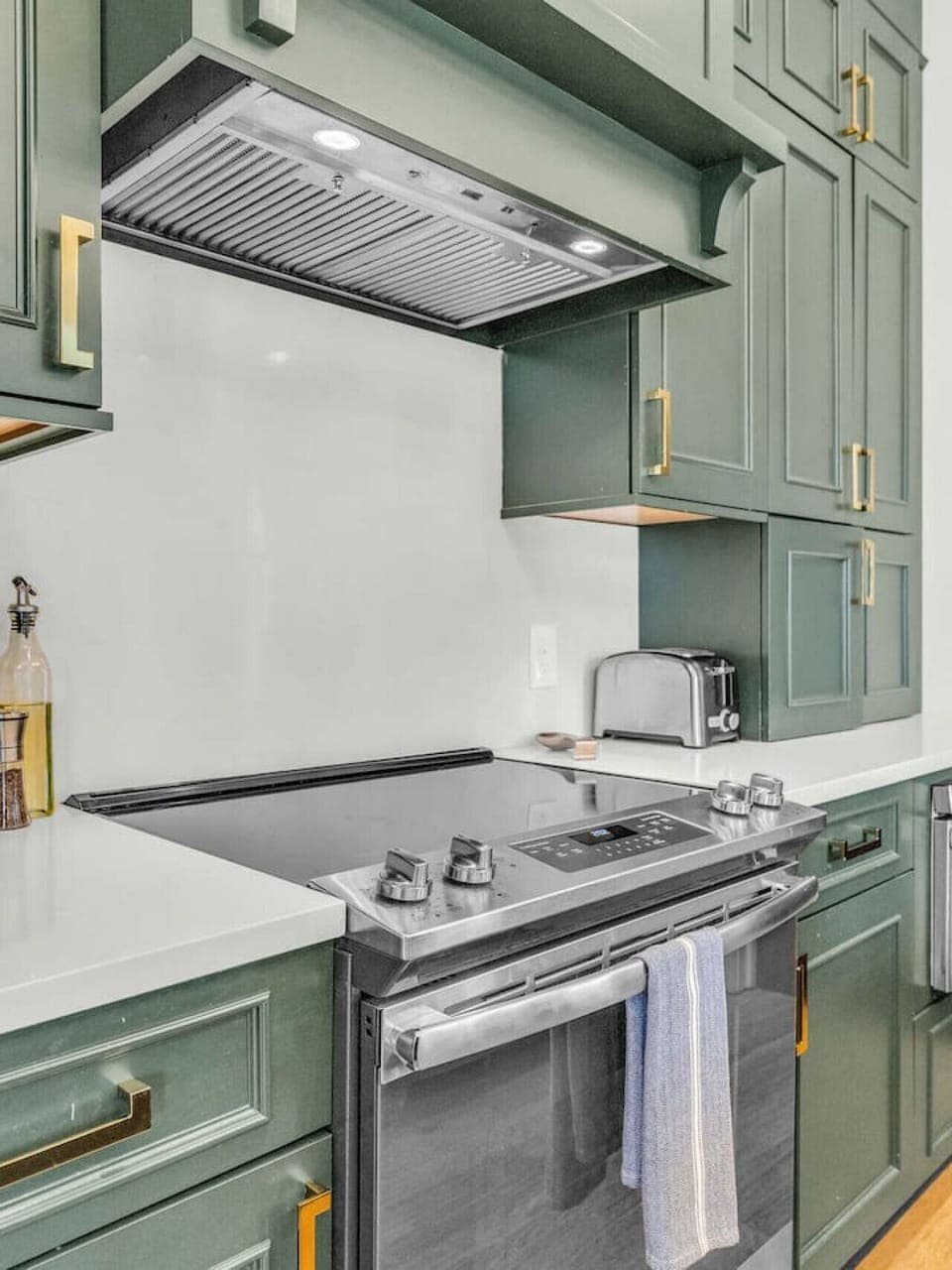 Gourmet Kitchen: Cook up a feast in this stylish kitchen with elegant green cabinetry and modern amenities!