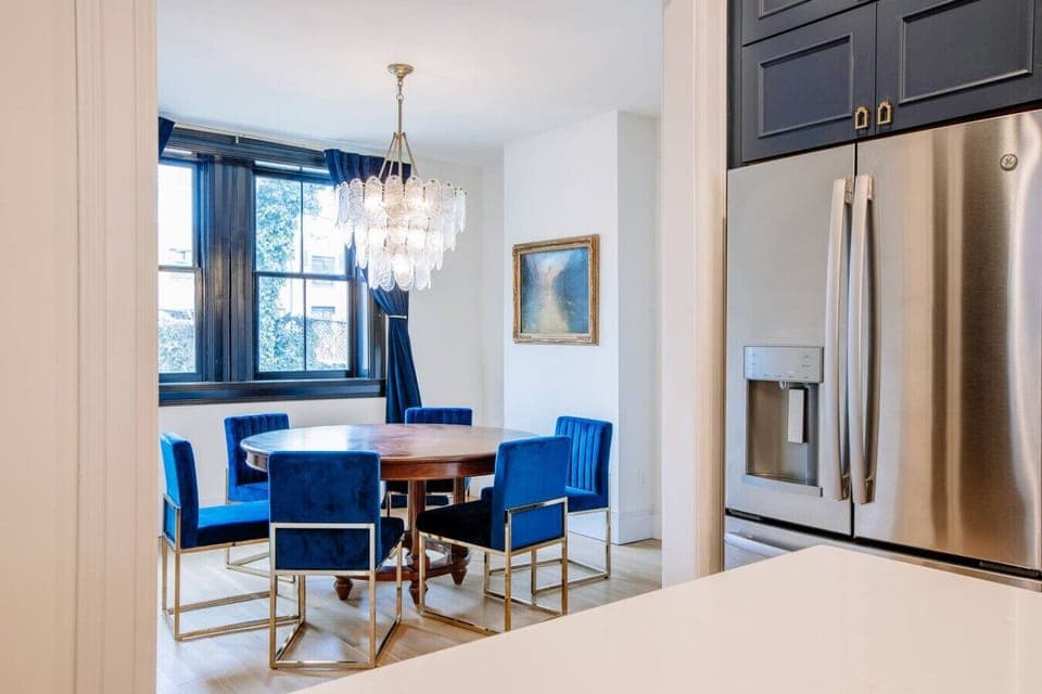 Dining Room: Elegant space with striking blue chairs and a stunning chandelier—perfect for gatherings!