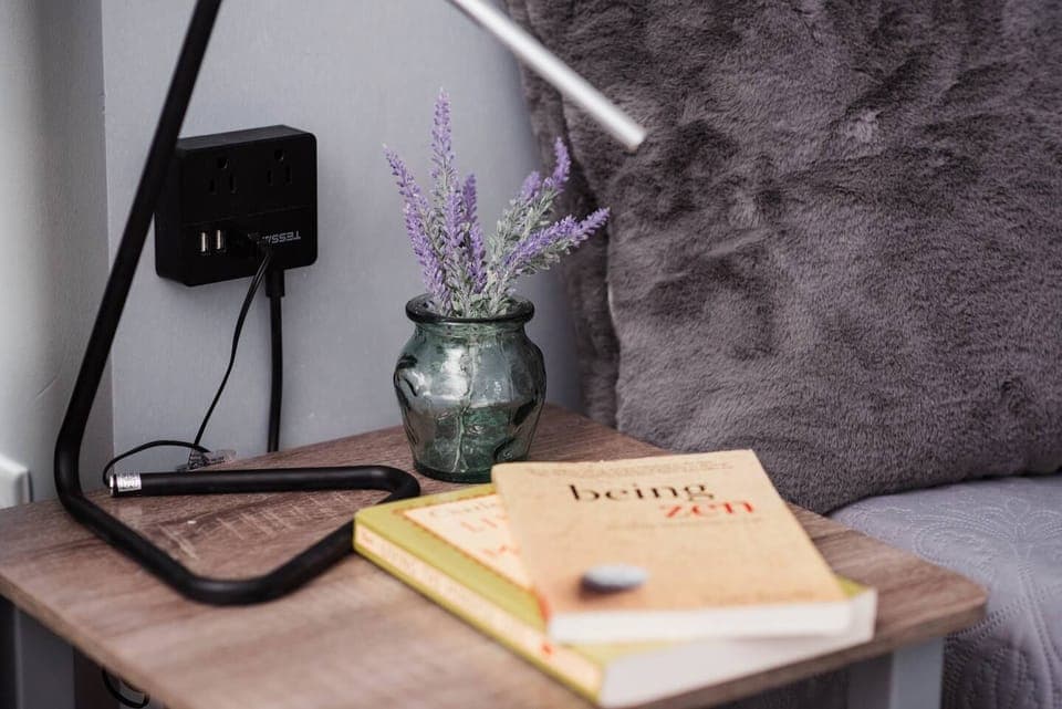 Charging ports and lamps next to beds