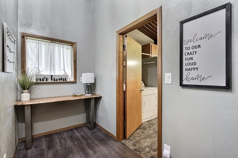 Entry hallway leads into half bath and laundry room