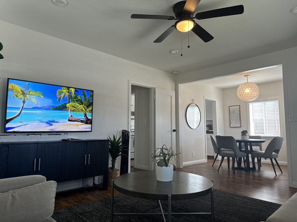 Bright and modern living space with a cozy vibe, smart TV, and open dining area.