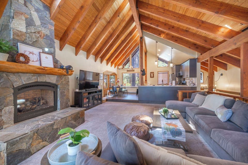 Big family room with custom sectional couch, huge raised ceilings and fireplace