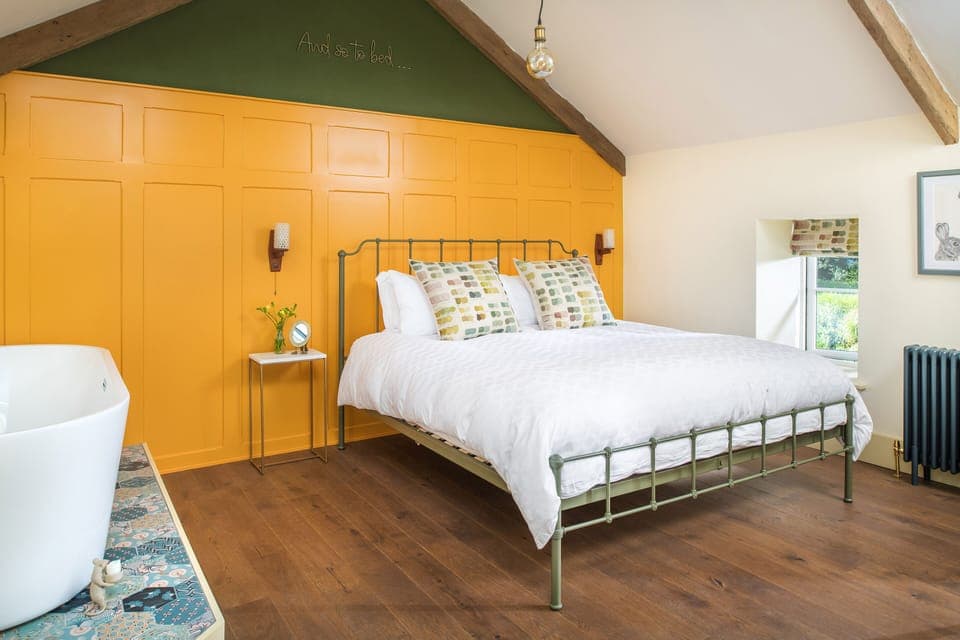 Panelled bedroom with Super King size bed and free-standing bath