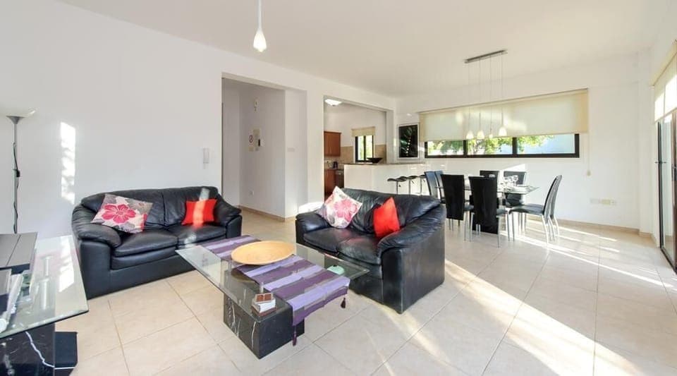 Living room with leather sofas and widescreen TV