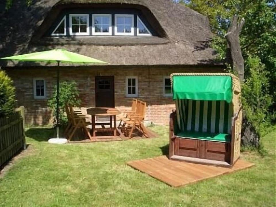 Experience the charm of this thatched house with garden furniture for relaxing hours.