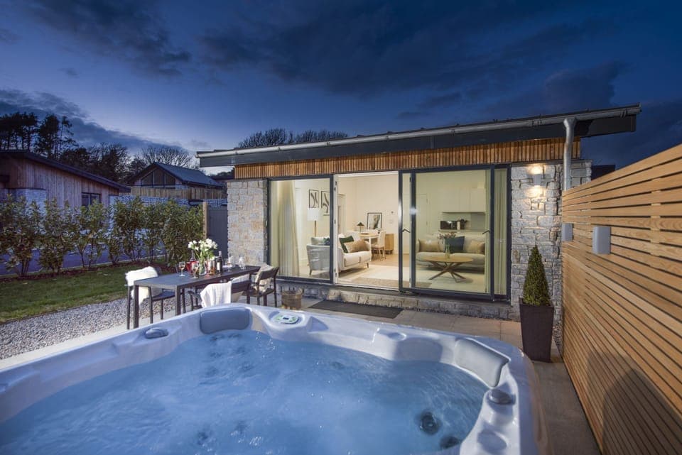 Hot tub in the patio area, sliding doors and table seating for 4 guests outside - Salt Life, Dunes at Upton Towans