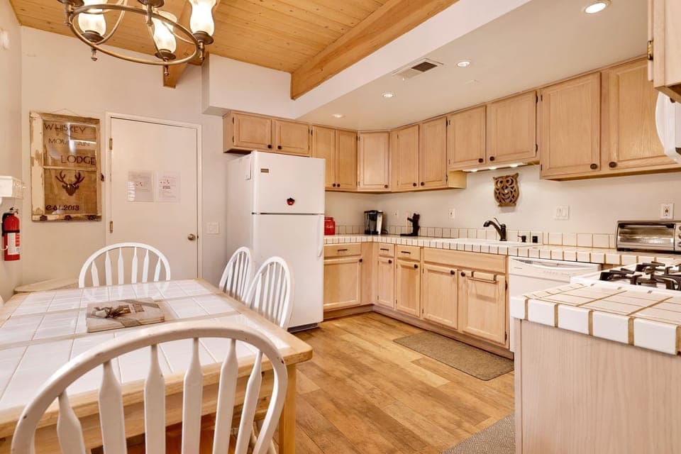 Fully equipped cabin kitchen with ample cabinetry, stove, fridge, microwave, and coffee maker—perfect for cooking meals, morning coffee, and feeling right at home on your stay.