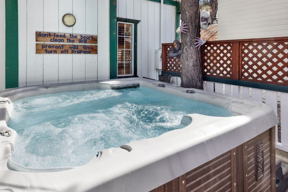 Private outdoor hot tub surrounded by tall pines, perfect for relaxing under the trees after a day of adventure—enjoy peaceful forest views, fresh air, and a truly rejuvenating stay.