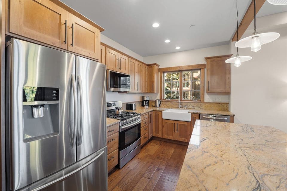 Modern full size kitchen offering granite countertops, beautiful cabinetry, and stainless steel appliances throughout.