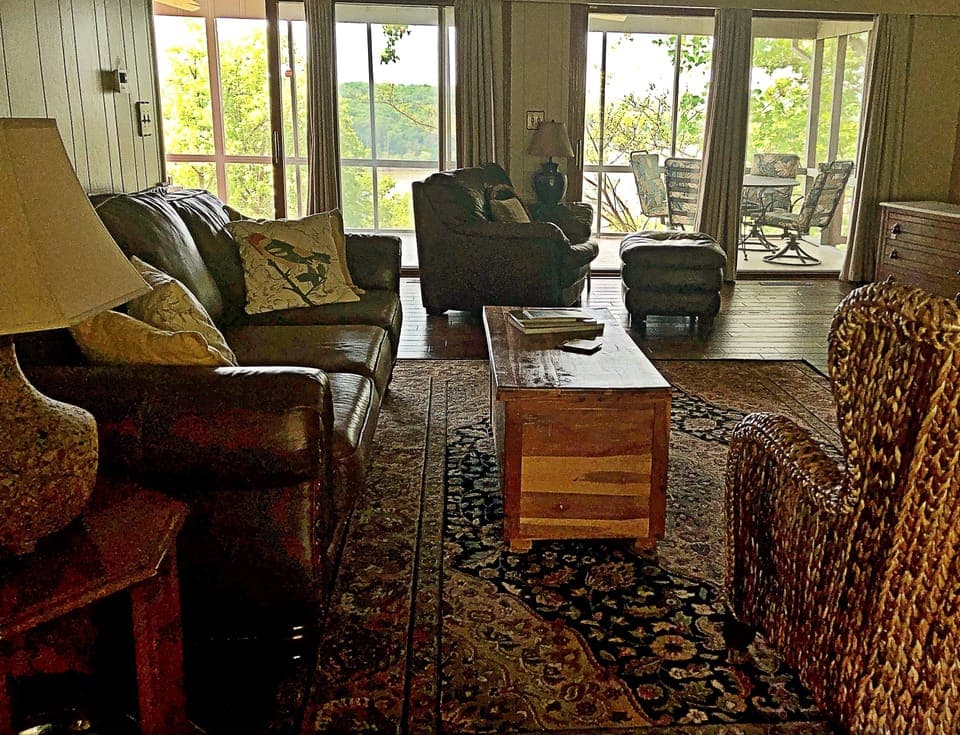 Spacious living room that opens up to the screened-in porch and lake view.