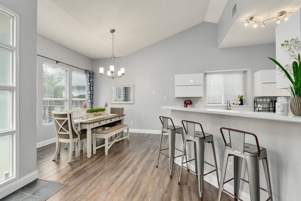 Gather around the open dining space with bar seating, vaulted ceilings, and easy-flow comfort—A Stay Above The Rest.