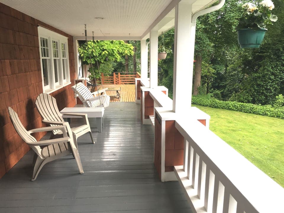 Wrap around porch with a cozy porch swing, perfect for a relaxing evening.