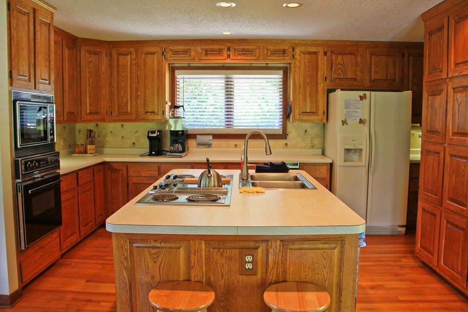 Fully equipped kitchen with dishes, cookware, and retro appliances. 