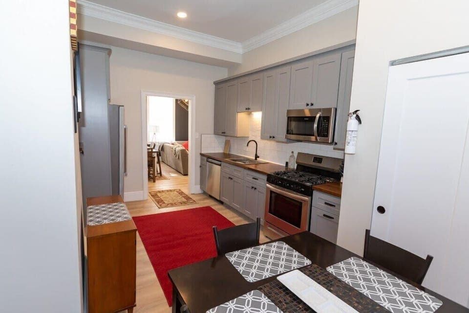 A luxuary kitchen, with plenty of cabinets and cooking prep space.  Large 6 burner stove, coffee station, and smaller table. 
