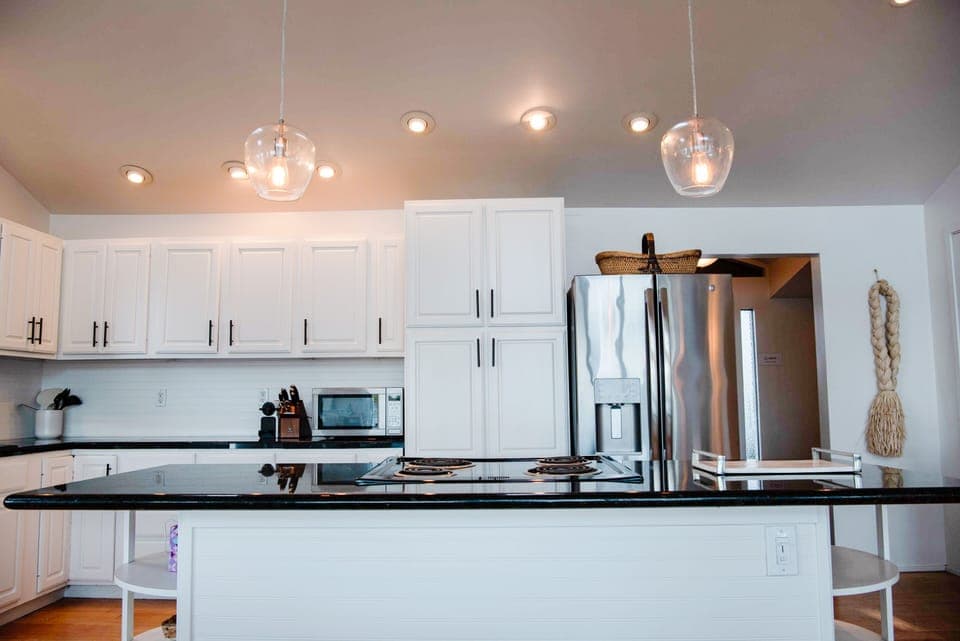 Expansive kitchen with granite countertops and stainless steel appliances.