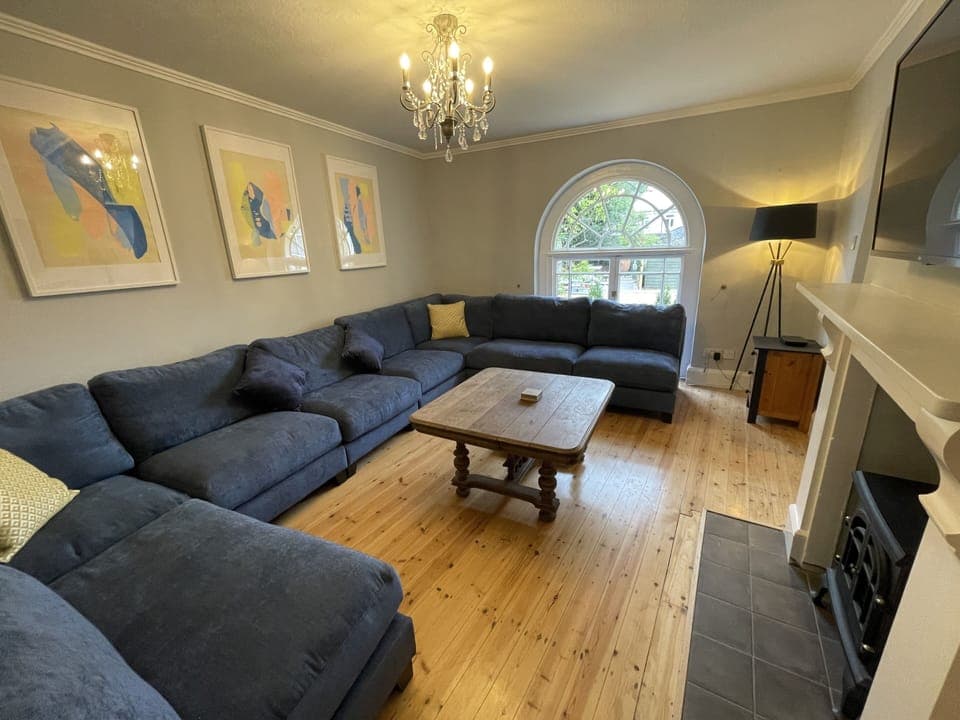 Living room with wall mounted smart tv connected to sky