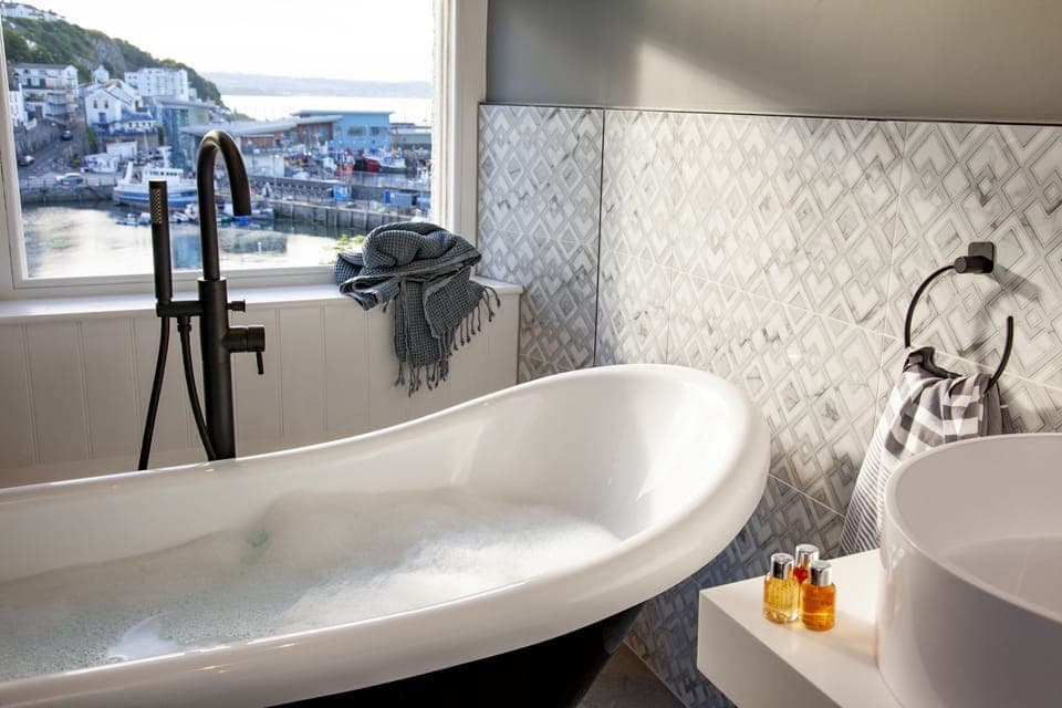 Freestanding bath with views over Brixham harbour - Leader Suite