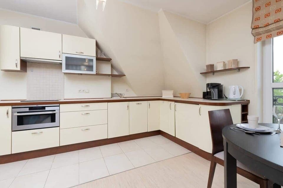 A modern kitchen with white cabinets, built-in appliances, and plenty of counter space.