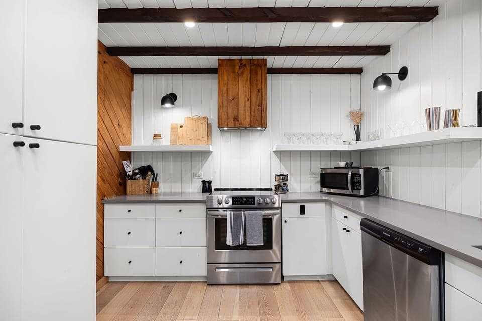 Fully equipped kitchen with stainless steel appliances, cookware, bakeware, blender, and everything you need to dine in.