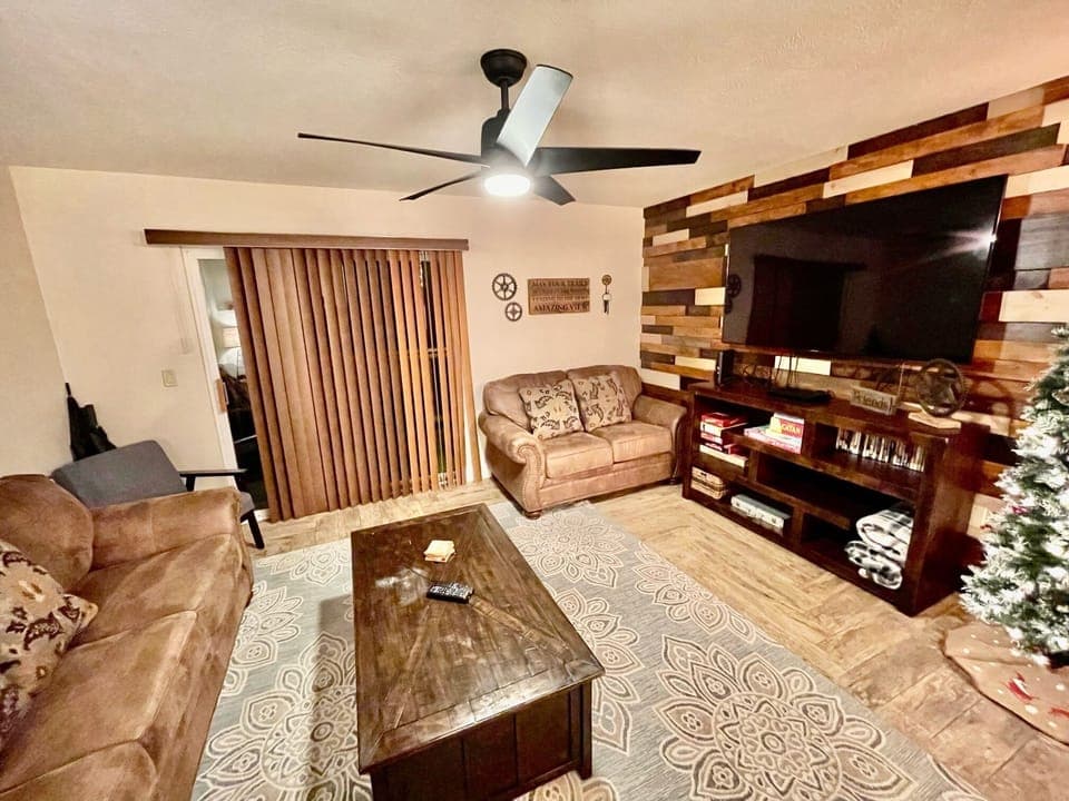Family room w/ sleeper sofa and loveseat and 55" Smart TV in unit 4