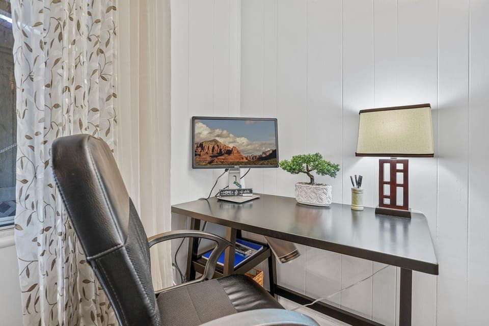 Work space with a monitor to catch up on important emails or take zoom calls.