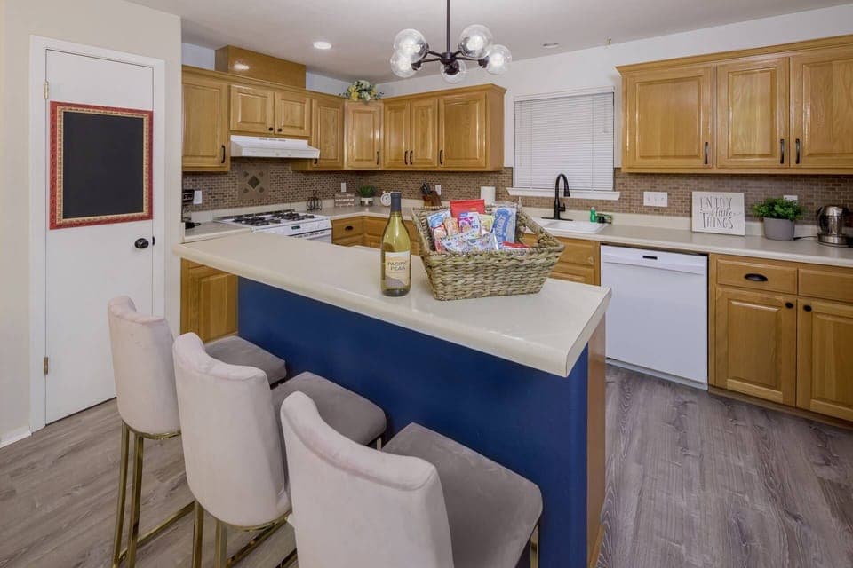 Well stocked kitchen with countertop seating with open floor plan