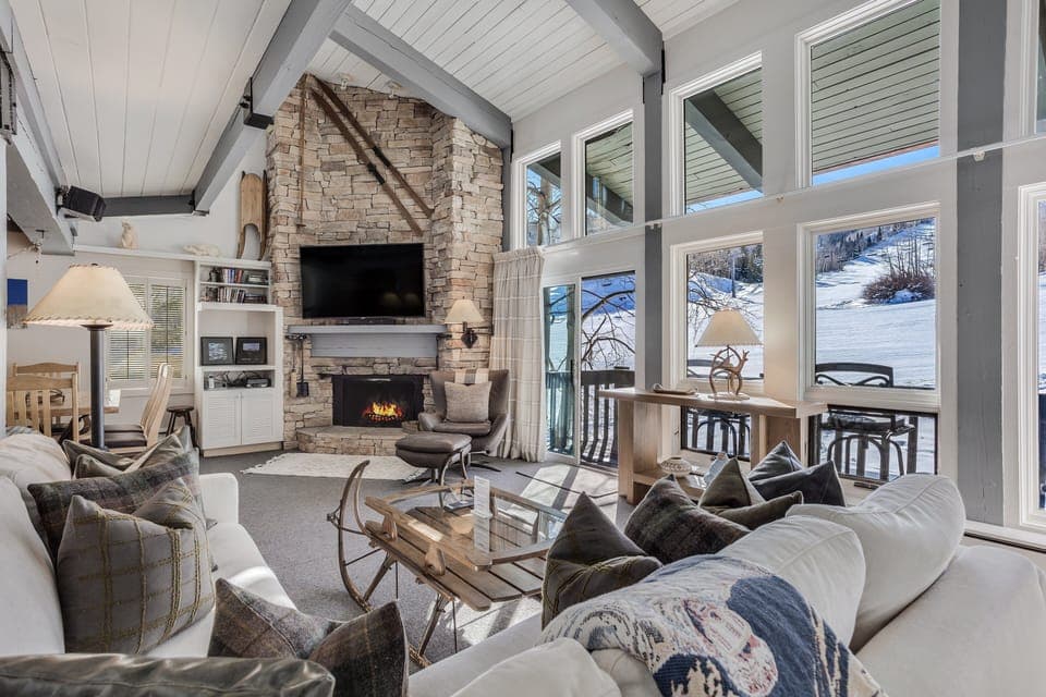 Slope-facing living room with wood-burning fireplace