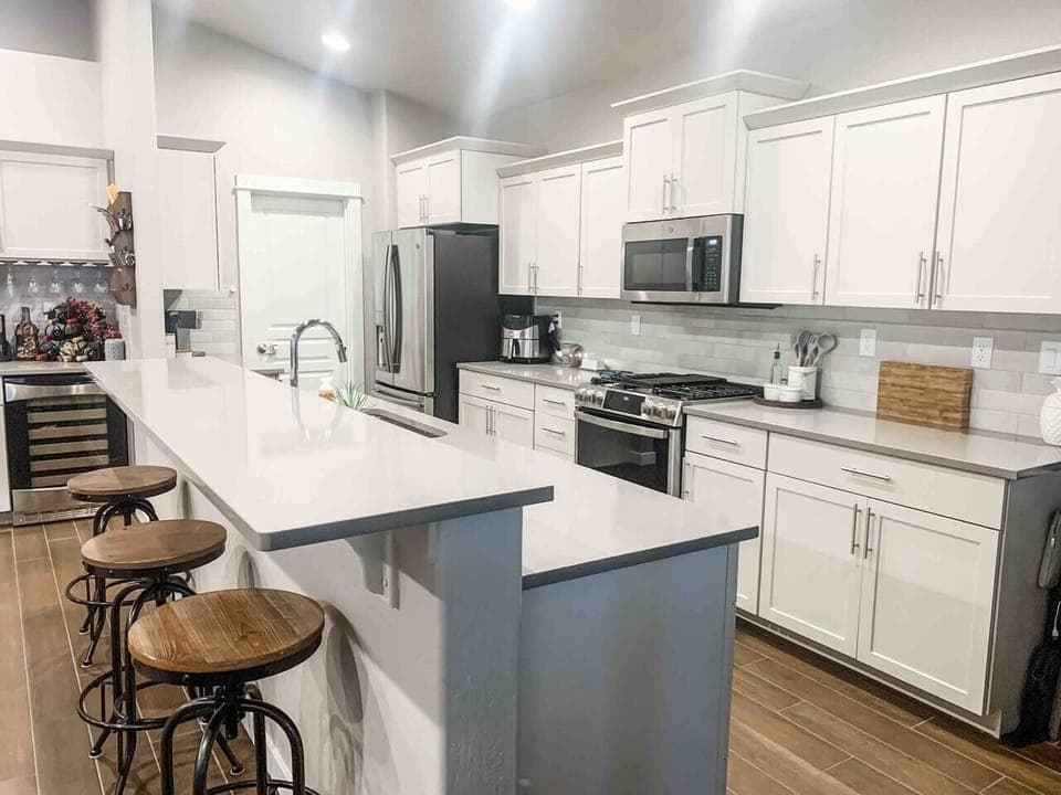 Kitchen features 3 barstools for additional seating, GE Profile appliances (gas stove, refrigerator, microwave, and dishwasher). Cuisanart single serve coffee makers (KCups included!)