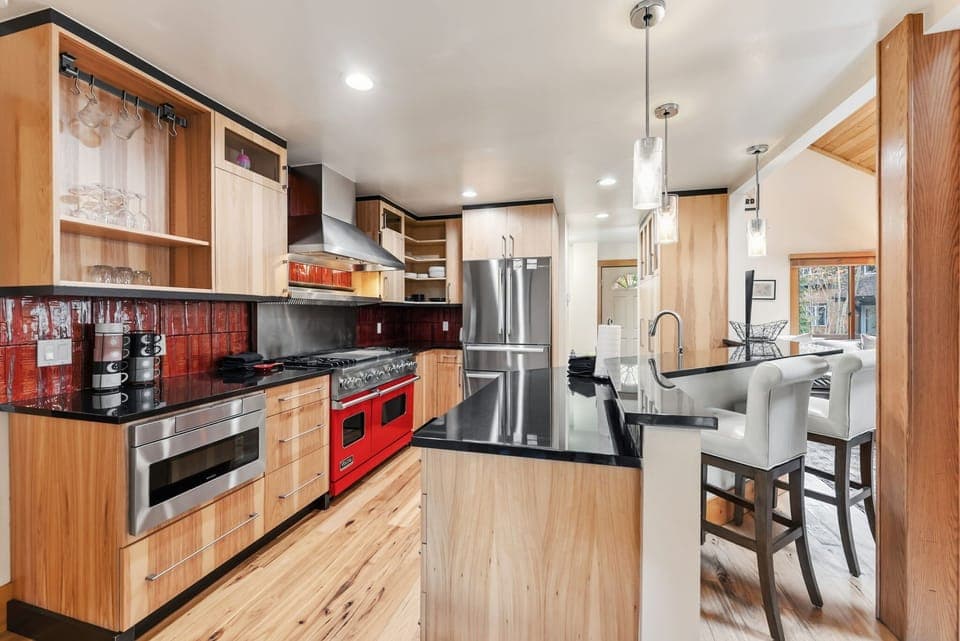 Kitchen: Viking appliances, drip coffee maker, Keurig, cooking utensils, tableware, bar seating