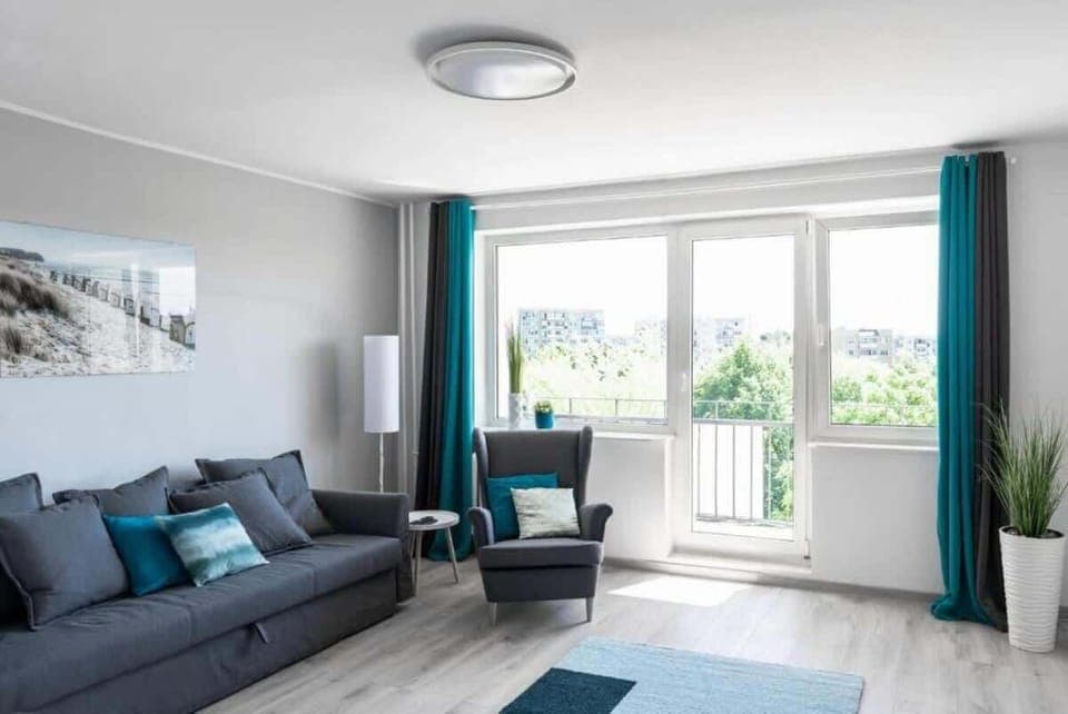 Relax in the stylish living room with a comfortable sofa and modern decor.