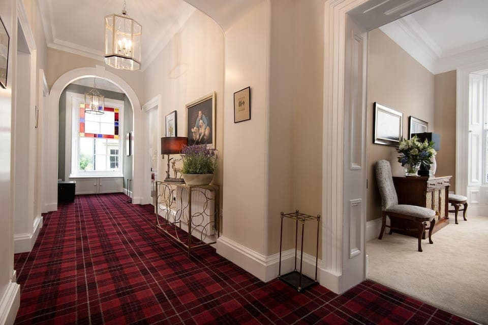 The Linen House - impressive first floor hallway with grand proportions and stunning architrave mouldings and cornicing
