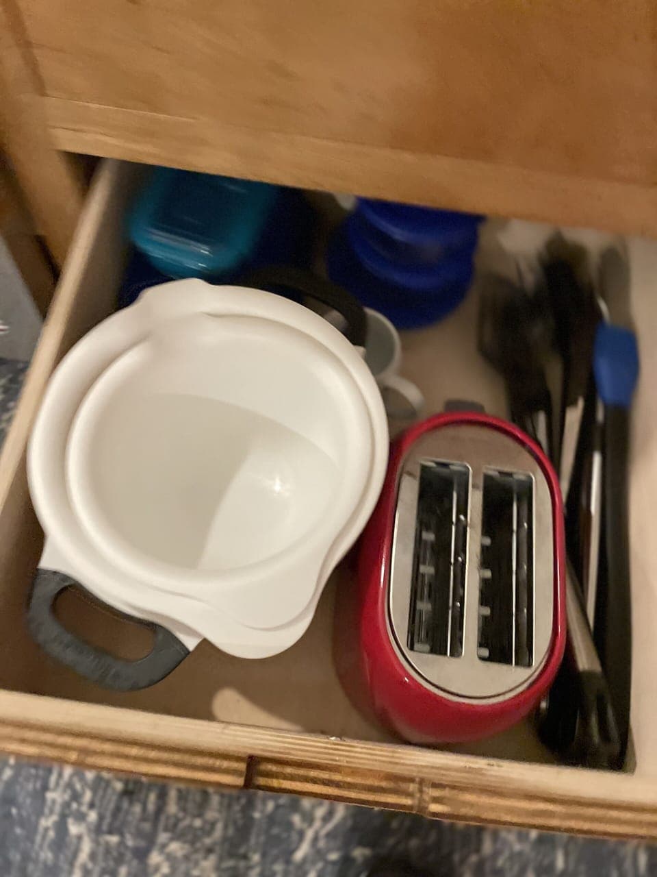 Bowls and toaster, along with other utensils. 