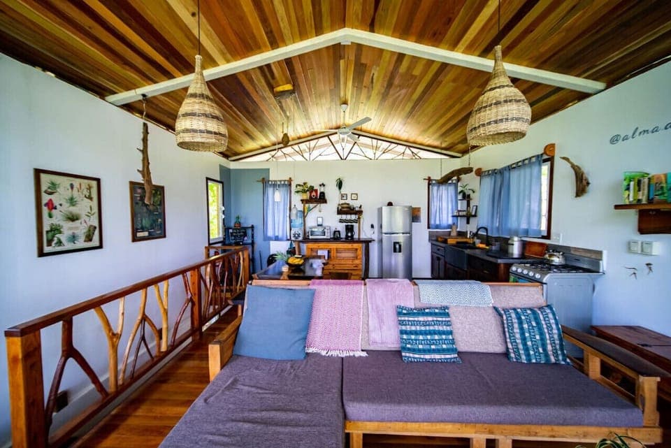 Open plan living area with river views and jungle surroundings