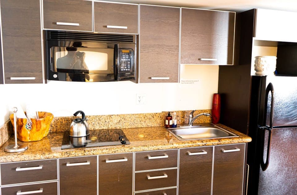 Kitchen with stove, oven, sink, and microwave