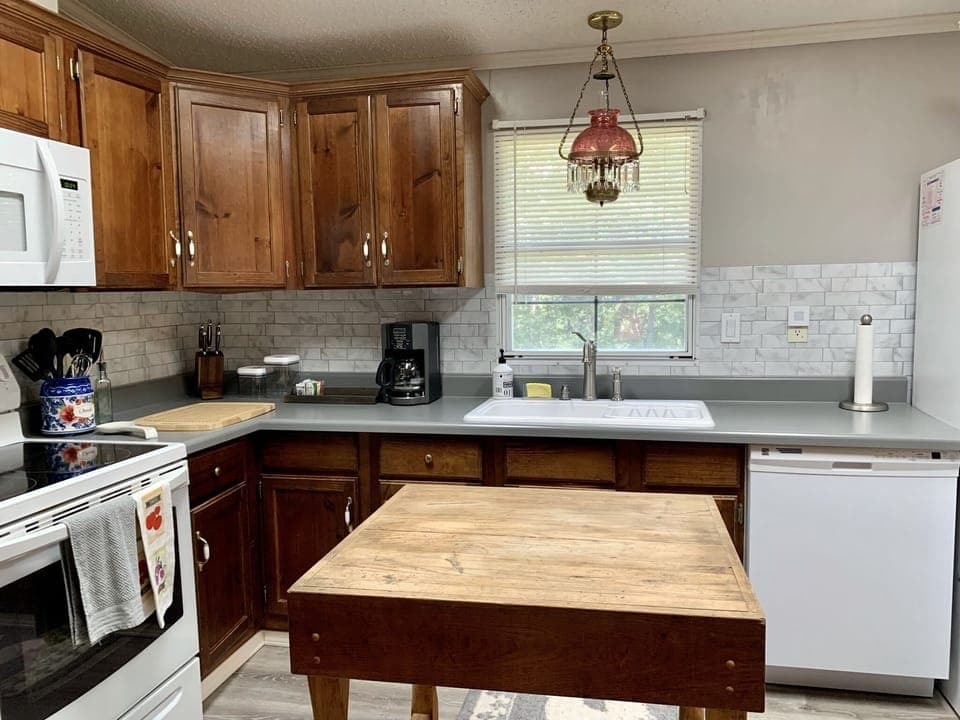 The full kitchen features a butch-block island.