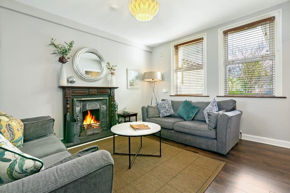 Our living room greets w/ an inviting atmosphere and warm décor.